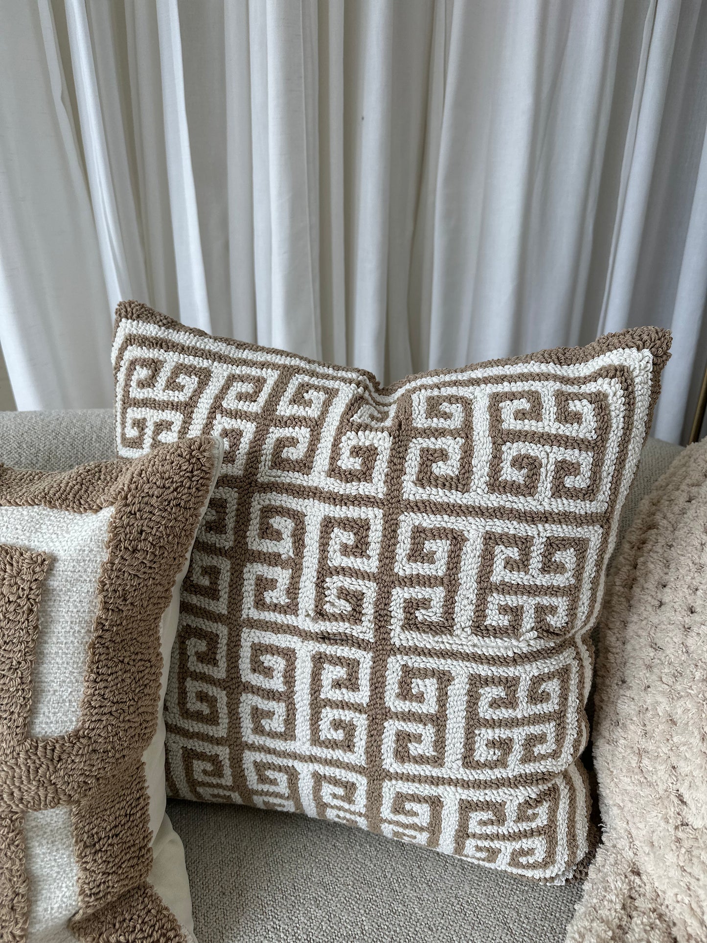 Decorative pillow with geometric pattern on a textured surface